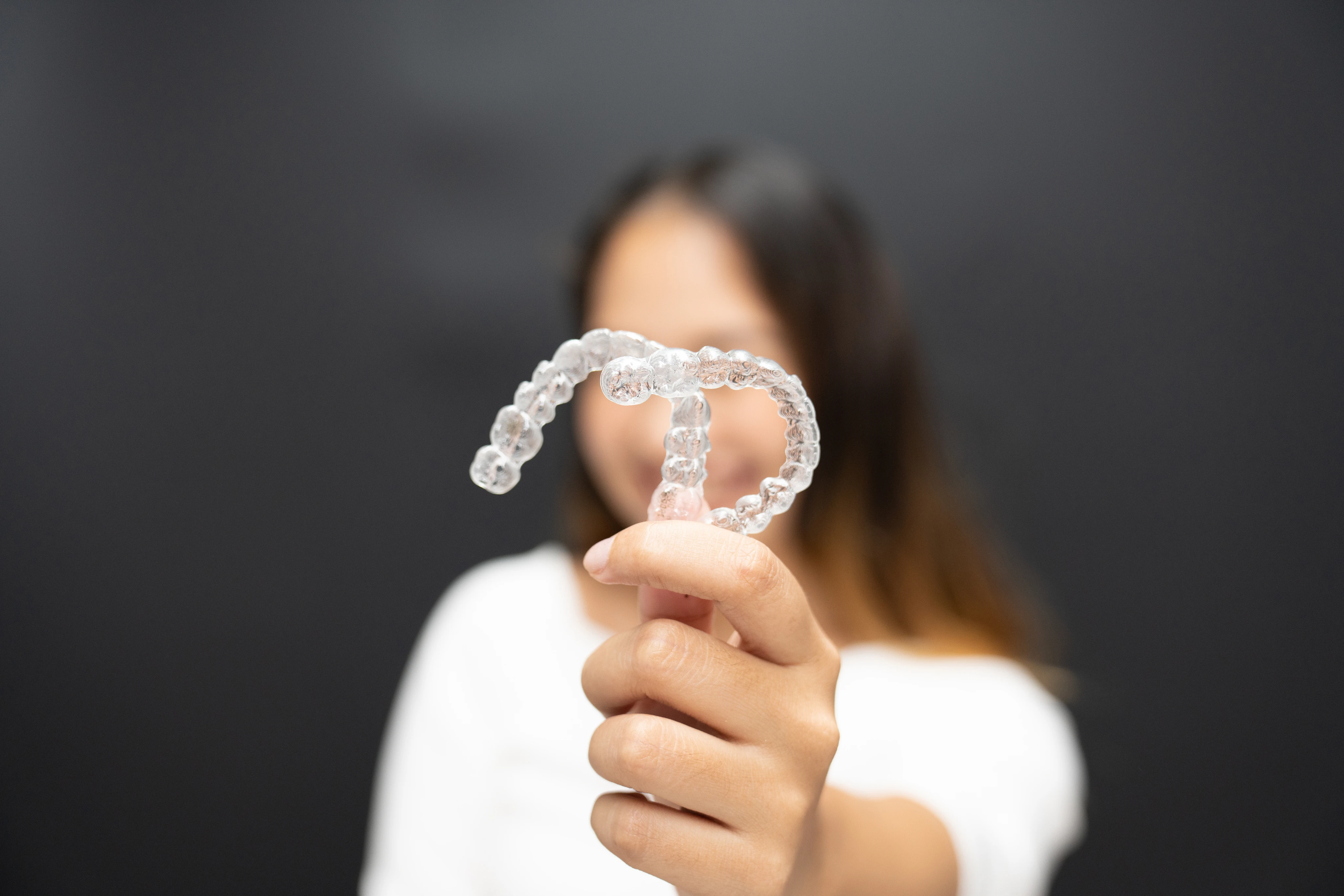 Close-up of clear aligners worn on teeth